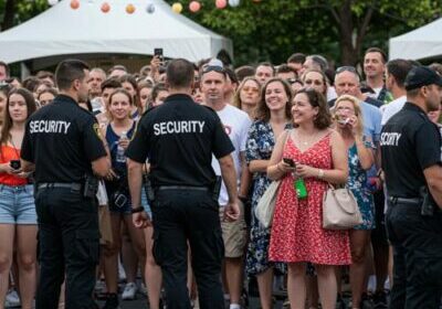 Security officers managing crowd at outdoor event
