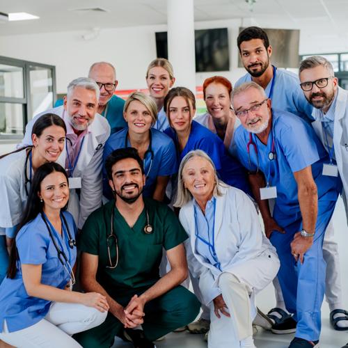 Group of smiling doctors and nurses posing together